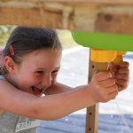 Mädchen lernt Melken - Käserei Woerle